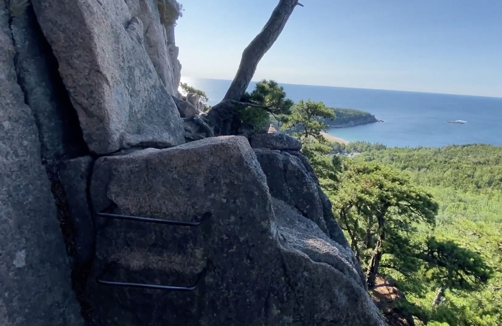 Granite ridges, evergreen forest, and the Atlantic coast seen from the Beehive in Acadia