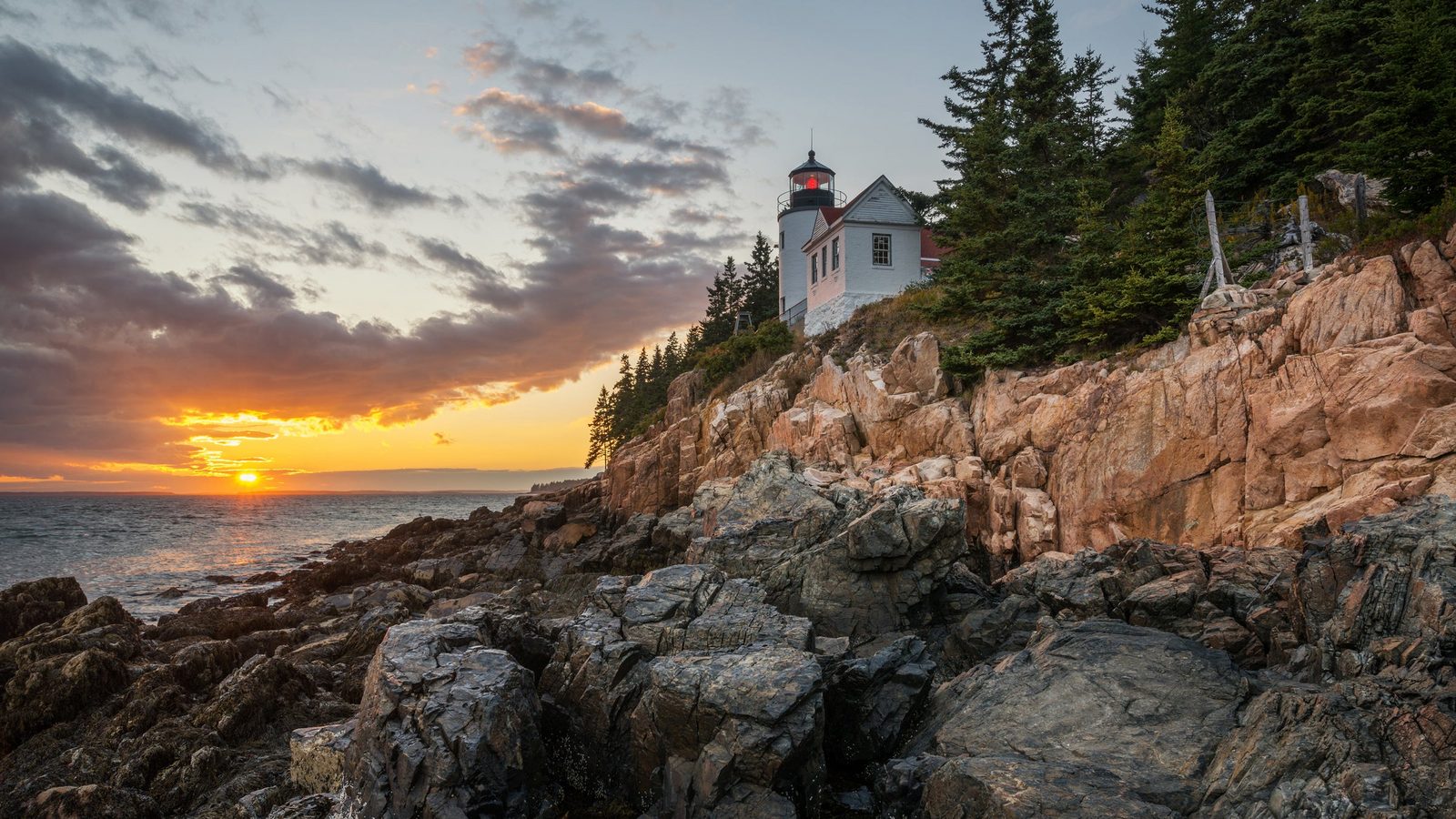 Bass Harbor Head Light at sunset on the rocky shore of Mount Desert Island