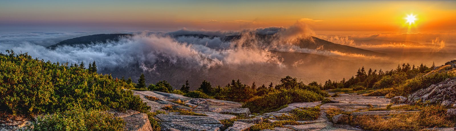 Sunrise color over Acadia granite and water
